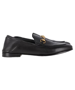 VINTAGE, RRP AS NEW
Gucci’s Brixton Convertible Loafers in Black Leather are the epitome of understated luxury and versatility. Made from incredibly soft black leather, these loafers feature the brand’s signature horsebit detail, adding a touch of elegance. The innovative design lets you wear the heel up for a polished loafer look or fold it down to create a comfortable, chic slipper. The leather lining and sole provide a smooth, luxurious fit, making these shoes perfect for all-day wear.

with Box, Dust bag

Gucci Brixton Convertible Loafers in Black Leather
Condition: very good
Signs of wear: Include Box., No visible sign of wear. No Mark at insole.,  Very light mark at soles.
Packaging: Box, Dust bag
Color: black
Material: Leather | leather
Size: EU | 37
Measurements: Insole length: 270
SKU: NAPPUGBSH466107W
