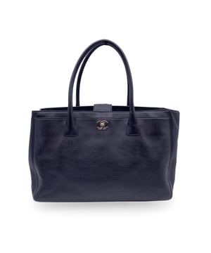VINTAGE, RRP AS NEW
Stunning Chanel 'Executive' Tote Bag in black pebbled leather. Period/Era: 2010/2011. Silver metal CC - CHANEL logo on the front. Double top handles and removable shoulder strap. Double magnetic button closure on top. Front and rear pocket. Black grosgrain lining. 2 side zip pockets inside and a fabric removable pouch inside. 'Chanel - Made in Italy' tag inside. ity hologram tag inside. Condition Rating: A - EXCELLENTCondition Details: Gently used. Minimal wear of use on bottom corners. Please, check carefully the photos or ask if you have any doubts.Measurements (cm):Depth: 15.2Height: 22.9Length: 35.6Other Details: Dustbag? YesKeys? NoBox? Yes Measurments:  width: 152 mm length: 356 mm height: 229 mm