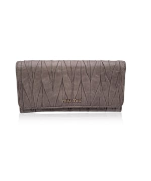 VINTAGE, RRP WIE NEU  
Elegant und mit einem Hauch von Kante, ist dieses Miu Miu Continental Wallet ein verfeinerter Klassiker, eingehüllt in taupefarbenes Matelassé-Leder mit einem subtilen, abgenutzten Effekt, der genau den richtigen Charakter zu seiner eleganten Silhouette hinzufügt. Das ikonische goldene MIU MIU-Logo glänzt auf dem Verschluss, der mit einem dezenten Knopf gesichert ist. Öffnen Sie es, um ein durchdacht gestaltetes Inneres zu enthüllen: 12 Kreditkartenfächer, zwei geräumige Fächer, ein Münzfach mit Reißverschluss und eine seitliche offene Sektion, die ordentlich unter dem Verschluss verborgen ist. Innen ist 'MIU MIU' in das Leder eingeprägt, mit einer Seriennummer, die als leise Markierung der Authentizität dient. Unaufdringlich und endlos schick, ist dieses Stück mehr als nur eine Geldbörse – es ist ein kleines Stück von Miu Mius verspielter Eleganz, das dazu gemacht ist, getragen und geschätzt zu werden.  
Zustandsbewertung: B - SEHR GUTER ZUSTAND  
Zustandsdetails: Sanft gebraucht. Einige leichte Kratzer auf dem Leder aufgrund normalen Gebrauchs. Miu Miu-Box enthalten. Bitte überprüfen Sie die Fotos sorgfältig und fragen Sie, wenn Sie mehr Details wissen möchten oder Zweifel haben.  
Maße (cm): Höhe: 10,2 Länge: 19,1  
Box?: Ja  
Maße: Länge: 191 mm Höhe: 102 mm