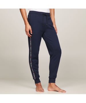 Elasticated drawstring waist.Two front slit pockets.Tommy Hilfiger repeat logo tape at sides.Rib-knit waistband and cuffs.Signature drawstring ends.Tommy Hilfiger flag embroidery on pocket.