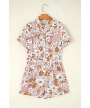 Our styles are designed with a trendy fitted look in mind following an international size standard. For the best fit we suggest choosing one size up from your usual. Be sure to check our sizing chart to find your perfect match!
  Pink floral short sleeve collared button front romper
  Perfect for summer days with a playful flower print
  Short cuffed sleeves and cuffed hem
  Collared neck and buttoned bodice
  Features chest pockets and pocketed shorts
  Elastic back waistline for a comfortable fit
Material: 100% Polyester