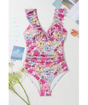 Our styles are designed with a trendy fitted look in mind following an international size standard. For the best fit we suggest choosing one size up from your usual. Be sure to check our sizing chart to find your perfect match!
  One
  piece swimsuit
  Pink floral design
  V neckline with ruffle details
  Lace
  up tie at the back
  Tummy control feature
  High stretch material
  Classic bum coverage