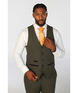 Add a refined edge to your outfit with this premium wool blend waistcoat, crafted for both style and comfort. Whether layered over a shirt for formal events or paired casually, this vest offers timeless versatility. Made from a high-quality blend of 52% polyester and 48% wool, it delivers warmth, durability, and a soft feel throughout the day. The tailored fit provides a sleek silhouette, while the rich Olive Green tweed fabric brings depth and character to your look.
Premium Fabric: Soft and durable wool blend for all-day comfort.
Tailored Fit: Sharp, polished cut that enhances your overall ensemble.
Tweed Texture: Classic Olive Greentweed for a sophisticated, heritage-inspired aesthetic.
Functional Design: Includes practical pocket detailing for everyday convenience.
Perfect for weddings, business attire, or smart-casual styling, this waistcoat is a versatile addition to any modern wardrobe.