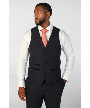 Añade un toque refinado a tu outfit con este chaleco de mezcla de lana premium, confeccionado para brindar estilo y comodidad. Ya sea que lo uses sobre una camisa para eventos formales o lo combines de manera informal, este chaleco ofrece una versatilidad atemporal. Hecho de una mezcla de alta calidad de 52% poliéster y 48% lana, brinda calidez, durabilidad y una sensación de suavidad durante todo el día. El ajuste entallado proporciona una silueta elegante, mientras que el rico tejido de tweed azul marino aporta profundidad y carácter a tu look. Tejido premium: Mezcla de lana suave y duradera para una comodidad durante todo el día. Ajuste entallado: Corte elegante y pulido que realza tu conjunto general. Textura de tweed: Tweed azul marino clásico para una estética sofisticada de inspiración tradicional. Diseño funcional: Incluye prácticos detalles de bolsillo para mayor comodidad diaria. Perfecto para bodas, atuendos de negocios o un estilo elegante e informal, este chaleco es una adición versátil a cualquier guardarropa moderno.