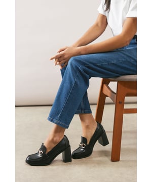 Faux leather loafers with distinctive snaffle detail
        Comfortable mid-height block heel (5-6.5cm)
        Sleek almond toe shape for a refined silhouette
        Versatile slip-on design for easy wear
        Chunky sole adds a contemporary edge
    
    The Junelith loafers from Wallis blend timeless sophistication with modern flair. These faux leather beauties feature a striking snaffle detail that adds a touch of equestrian-inspired elegance to your ensemble. The mid-height block heel offers the perfect balance of comfort and style, making these loafers ideal for long days at the office or casual weekend outings. Pair them with tailored trousers and a crisp blouse for a polished work look, or dress them down with your favourite jeans and a cosy jumper for a chic brunch date. The versatile design of these loafers ensures they'll become a go-to choice in your wardrobe, seamlessly transitioning from day to evening wear with effortless grace.