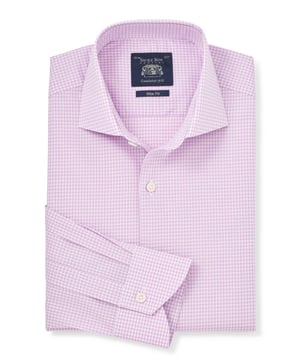 Introducing our bestselling gingham formal shirt in lilac - the perfect addition to your wardrobe for a sophisticated look. Crafted with meticulous attention to detail, this men's shirt offers a sleek silhouette and a timeless design. Slim fit and flattering; gently tapered shape for all builds. Made from 100% BCI cotton poplin and featuers a curl resistant cutaway collar with integral and removable collar stay, and stylish curved edge single cuffs.