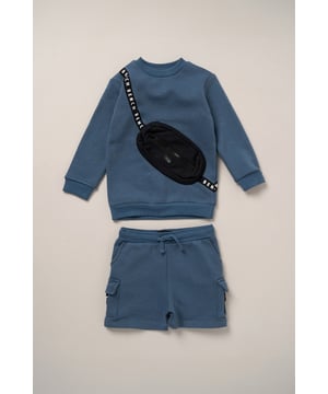 This 2-piece set from Bench includes a standout sweatshirt with a stitched imitation cross body bag detail and matching shorts for a coordinated, streetwear-inspired look. Made from soft brushed sweat fabric and finished with ribbed trims for comfort, it’s an easy go-to for laid-back days. The playful bag detail brings added personality, while the matching shorts complete the look with ease. Perfect for casual wear with a cool, urban edge.