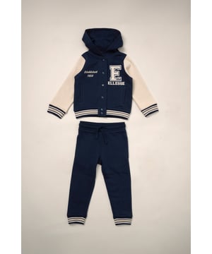 Bringing varsity vibes to mini wardrobes, this Ellesse hoodie and jogger set is made for standout style and all-day comfort. The letterman-inspired hoodie features contrast sleeves, bold collegiate branding, and ribbed trims for a snug fit. Paired with matching joggers in soft brushed-back fabric, it’s a go-to look for cooler spring/summer days.