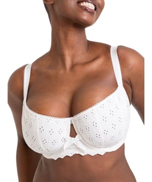 Curvy Kate Flora Balcony Bra. Underwired non padded balcony bra with uplifting vertical seams, broderie anglaise inspired embroidered fabric, cotton trims, scalloped edging and bow detailing. The product is recommended for hand wash only.