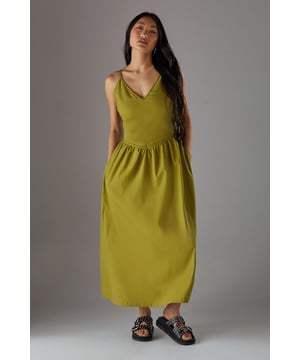 Linen blend midi sundress with flattering plunge neckline
        Adjustable spaghetti straps for a personalised fit
        Gathered waist detail creating a feminine silhouette
        Practical side pockets for everyday functionality
        Fully lined for comfort and ease of wear
    
    This effortlessly chic sundress from Warehouse combines casual comfort with sophisticated style. The plunge neckline adds a touch of allure while the gathered waist creates a flattering shape that complements the flowing midi length. Perfect for warm-weather occasions, style with flat sandals as seen on our model for a relaxed daytime look, or dress up with espadrille wedges and statement earrings for garden parties. The linen blend fabric offers a natural drape that moves beautifully with you, making it ideal for summer strolls or casual brunches with friends. The versatile design works equally well with a denim jacket for cooler evenings or worn alone to showcase its elegant simplicity. A wardrobe essential that transitions seamlessly from city breaks to countryside weekends.