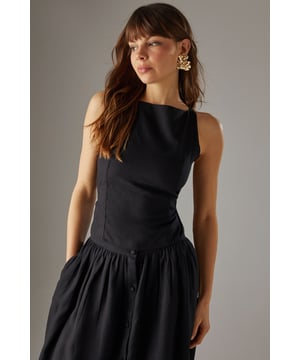 Sleek racer neckline with striking cross-back detail for a contemporary silhouette
        Cropped length perfect for high-waisted styling options
        Linen blend fabric offers breathable comfort with a natural texture
        Tie-back fastening allows for customisable fit
        Versatile design transitions effortlessly from day to evening wear
    
    This sophisticated crop top showcases a distinctive racer front with an eye-catching cross-back design that reveals just the right amount of skin. The textured linen blend fabric creates a refined yet relaxed aesthetic that's perfect for warm-weather styling. Pair with the matching wide-leg culottes as shown for a coordinated ensemble that radiates effortless chic, or style with high-waisted denim and strappy sandals for casual daytime events. For family gatherings or weekend brunches, layer with a lightweight cardigan and accessorise with statement earrings to enhance the look. The versatile nature of this piece makes it an essential addition to your summer wardrobe, offering countless styling possibilities whilst maintaining that confident Warehouse edge. The cropped silhouette works beautifully with higher-rise bottoms to create a balanced and flattering proportion.