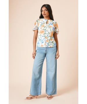 Delicate mesh fabric with floral print for a feminine touch
        Elegant keyhole detail at the neckline adds subtle interest
        Ruched front design creates a flattering silhouette
        Angel sleeves provide graceful movement and coverage
        Regular fit ensures comfortable wear for all-day events
    
    This charming mesh top from Dorothy Perkins combines comfort with style for the woman who appreciates subtle trends. The ruched front detail creates a figure-flattering effect whilst the angel sleeves offer a soft, feminine silhouette with just the right amount of coverage. Style this versatile piece with wide-leg denim as shown for casual brunches with friends, or pair with tailored trousers for family gatherings. The keyhole detail adds a touch of interest without revealing too much. Perfect for those who want to look put-together yet relaxed, this top transitions beautifully from daytime coffee dates to evening garden parties. Complete the look with simple flats and minimal jewellery for an effortlessly chic ensemble that reflects your personal style whilst maintaining comfort.