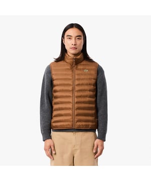 Water-Repellent Puffed Vest Water-repellent taffeta Recycled polyester filling  limiting the production of virgin materials Ecodown Fibers Loft thermal insulation 2 zipped pockets on hips Embroidered crocodile on chest