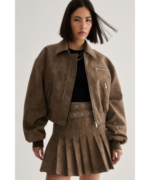 Distressed faux leather finish for an edgy, worn-in look
        Oversized silhouette with dropped shoulders for a relaxed fit
        Collar detail adds a classic touch to the modern design
        Multiple zip pockets for both style and functionality
        Ribbed cuffs and hem for a snug, comfortable fit
    
    This distressed faux leather bomber jacket from Nasty Gal is the epitome of effortless cool. The oversized silhouette creates a laid-back vibe, perfect for those who want to make a statement without trying too hard. Style it with a cropped black top and a pleated mini skirt for a balanced look that plays with proportions. For a casual day out, pair it with high-waisted jeans and chunky trainers. The jacket's versatility shines through when layered over a flowy maxi dress for an unexpected contrast. Ideal for family gatherings or casual nights out, this bomber adds an edge to any ensemble. The multiple zip pockets not only contribute to the jacket's rugged charm but also offer practical storage for your essentials. Whether you're heading to a gig or meeting friends for coffee, this jacket will be your go-to for an instant dose of attitude.
