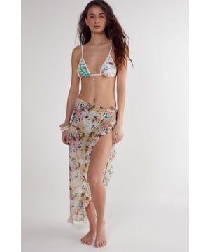 Flowing woven cotton beach skirt with eye-catching tie-dye pattern
        Feminine ruffle detailing along the edges for added movement
        High-slit design offering adjustable coverage and effortless movement
        Lightweight fabric perfect for warm-weather destinations
        Versatile wrap style that can be tied at desired height
    
    This breezy Nasty Gal beach skirt combines carefree style with practical beachwear functionality. The lightweight cotton construction ensures comfort during hot days by the shore, while the distinctive tie-dye pattern captures the essence of summer escapism. Wrap it around your waist as a chic cover-up when heading from the beach to a seaside caf, or style it with a matching triangle bikini top as shown for a coordinated look. The ruffle detailing adds a playful, feminine touch that catches the gentle sea breeze beautifully. Perfect for your holiday wardrobe, this versatile piece transitions effortlessly from poolside lounging to casual sunset strolls along the promenade. Pair with simple sandals and statement jewellery for an impromptu beach party, or throw on over your favourite swimwear for instant style when the ice cream van arrives.