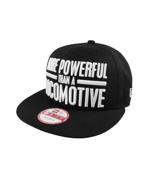An official New Era 9FIFTY Superman AKA snapback cap. Comes in solid black with a vivid red under visor and matching red adjustable strap. Features a large embroidered design across the front of the cap reading More Powerful Than A Locomotive in crisp white. Features iconic Superman logo along the side tying together the Superman theme. The official New Era logo can also be seen across the side in white along with the official sticker across the flat peak. Moisture wicking black sweatband. Adjustable back. Officially licensed merchandise. Made with 100% cotton.