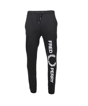 Experience ultimate comfort and style with our Fred Perry Large Branded Leg Black Sweatpants. Designed with a drawstring waist tie and cuffed legs, these pants provide a perfect fit for any body type. With 3 spacious pockets, including an iconic Fred Perry badge on the back, you'll have plenty of room to store all your essentials. Made from 66% recycled polyester and 34% cotton, these sweatpants are not only environmentally-friendly, but also incredibly soft and durable. Elevate your loungewear game to new heights with Fred Perry
