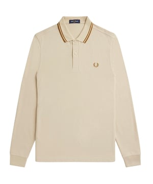 Achieve effortless style with the Fred Perry Long Sleeve Twin Tipped Oatmeal Beige Polo Shirt. Made from 100% cotton, this polo shirt is not only comfortable but also exudes a sense of luxury. Complete with the iconic Fred Perry badge on the left breast, this shirt is a timeless classic that never goes out of style. Perfect for any occasion, this shirt will elevate your look and make you feel confident and stylish. Don't miss out on the chance to own this must-have wardrobe staple