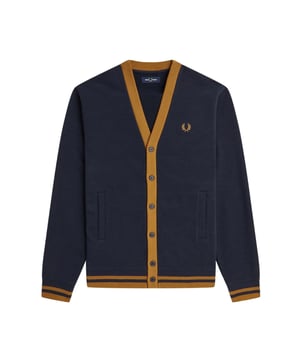 Experience the perfect blend of fashion and comfort with the Fred Perry Button Through Navy Blue Cardigan. Boasting a classic button fastening, long sleeves, and practical front pockets, this cardigan is a must-have for any stylish man. Crafted from 100% cotton, it's not only soft and breathable, but also a sustainable option for the environmentally conscious. Elevate your wardrobe with this versatile piece that will keep you looking sharp and feeling good all day long. Order now and experience the ultimate level of style and comfort!