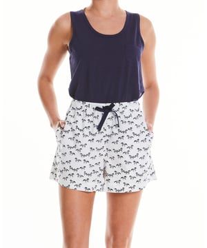 A must-have for animal lovers, this women's pyjama set includes a soft slub jersey vest and horse-print shorts made from organic cotton. A comfortable choice for bed, it's also great for lounging at home. Vest and lounge shorts set. Lily Of The Row branding. Vest 100% slubbed cotton single jersey 160gr; shorts 100% pure organic cotton printed poplin. Vest; small chest pocket. Scooped hem. Semi fitted. Centre back length on size 12 is 60cm. Shorts; navy herringbone tape drawstring at waist. Easy pull on shorts with side pockets. Relaxed fit. Inside leg on size 12 is 9.5cm. Machine wash at 40°C. Presented in fully recyclable packaging. Safety warning: keep away from fire.