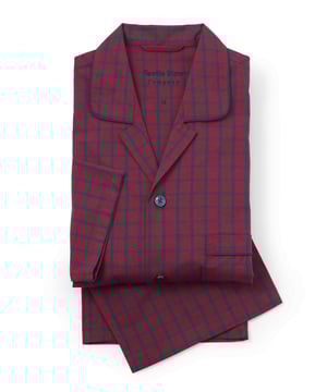 Indulge in classic comfort with our men’s check pyjamas. Crafted from soft, breathable cotton, these pyjamas offer the perfect balance of warmth and relaxation, making them ideal for lounging or sleeping in ultimate ease. The burgundy and navy check pattern brings a timeless charm to your sleepwear collection. Add a personalised touch with monogrammed initials, making these men’s pyjamas not just a wardrobe staple, but a thoughtful, customisable gift. 100% pure cotton poplin, cool and smooth to the touch. Chest pocket. Fully elasticated waist and working one button fly. Traditional classic style with Savile Row branding. Presented in fully recyclable packaging. Machine washable at 40°C.