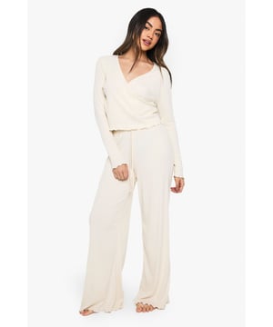 Ribbed jersey fabric for comfort and texture
        Wrap-style top with V-neckline for a flattering silhouette
        Wide-leg trousers for effortless lounging
        Coordinated set for a put-together look
        Long sleeves for cosy warmth
    
    Embrace laid-back luxury with this chic loungewear set from Boohoo. The ribbed jersey fabric offers a soft touch against the skin, perfect for those lazy days at home. The wrap-style top with its flattering V-neckline adds a touch of elegance to your relaxation time, while the wide-leg trousers ensure maximum comfort. Style this set for a Netflix marathon with fluffy socks and your favourite throw, or wear it for a casual brunch at home with friends. Add delicate gold jewellery for a hint of glamour, or keep it simple with a messy bun and your go-to pair of slippers. This versatile set transitions seamlessly from morning lie-ins to impromptu video calls, ensuring you look effortlessly stylish even in your most comfortable moments.