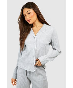 Ribbed jersey fabric for comfort and texture
        Long sleeves for cosy warmth
        Button-front design for easy wear
        Collared neckline adds a touch of sophistication
        Relaxed fit for unrestricted movement
    
    Embrace the ultimate in nighttime comfort with this rib long sleeve button front shirt from Boohoo. Perfect for those who appreciate style even in their sleepwear, this piece combines functionality with a dash of elegance. The ribbed jersey fabric offers a soft touch against the skin, while the long sleeves provide warmth for cooler nights. The button-front design allows for easy dressing and undressing, and the collared neckline adds a refined touch to your bedtime ensemble. Pair with the matching bottoms for a coordinated look, or mix and match with your favourite pyjama trousers for a personalised nightwear style. Whether you're having a relaxed evening in or preparing for a restful night's sleep, this versatile shirt ensures you'll look and feel your best.