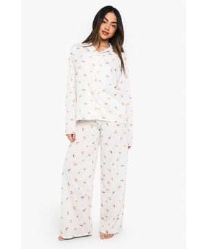 Charming ice cream print pyjama set
        Soft jersey fabric for ultimate comfort
        Long-sleeved button-up top with notched collar
        Matching wide-leg trousers for a relaxed fit
        Versatile two-piece design for mix-and-match options
    
    Indulge in sweet dreams with this delightful ice cream print pyjama set from Boohoo. Perfect for those who crave both style and comfort in their nightwear, this ensemble is crafted from soft jersey fabric to ensure a cosy night's sleep. The long-sleeved top features a classic button-up front and notched collar, adding a touch of sophistication to your bedtime routine. Paired with wide-leg trousers, this set offers unrestricted movement for ultimate relaxation. Whether you're having a lazy Sunday morning or hosting a girls' night in, this pyjama set is versatile enough to suit any casual at-home occasion. Mix and match the pieces with other items in your loungewear collection for endless styling possibilities. Embrace your playful side and make bedtime a little sweeter with this charming pyjama set.