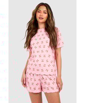 Playful cherry print pyjama set featuring a relaxed t-shirt top and matching shorts
        Soft jersey fabric ensures maximum comfort for lounging and sleeping
        Round neckline and short sleeves offer a classic, fuss-free silhouette
        Loose-fitting shorts with an elasticated waistband for unrestricted movement
        Versatile two-piece design perfect for year-round nightwear
    
    Add a touch of whimsy to your nightwear collection with this charming cherry print pyjama set from Boohoo. The relaxed t-shirt style top pairs perfectly with the comfortable shorts for a coordinated bedtime look that's both cute and practical. The lightweight jersey fabric feels wonderfully soft against the skin, making this set ideal for a restful night's sleep or lazy weekend mornings. Style with fluffy slippers and a cosy dressing gown during cooler months, or wear on its own during warmer weather. This playful set also makes for a delightful gift option or a treat for yourself when your nightwear drawer needs a refresh. The timeless silhouette and fun print reflect Boohoo's commitment to creating fashion that's both accessible and on-trend, ensuring you look stylish even when you're winding down.