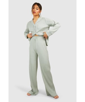 Ribbed jersey fabric for comfort and texture
        Tie waist detail for adjustable fit
        Wide-leg silhouette for relaxed style
        High-waisted design for flattering shape
        Coordinating top available for a complete set
    
    Embrace laid-back luxury with these rib tie waist lounge trousers from Boohoo. Perfect for those cosy nights in or lazy weekend mornings, these trousers offer both style and comfort. The ribbed jersey fabric feels soft against the skin, while the wide-leg silhouette allows for unrestricted movement. The high-waisted design with a tie waist detail not only adds a trendy touch but also ensures a customisable fit. Pair with the matching top for a coordinated loungewear look, or mix and match with your favourite tees and sweatshirts. Whether you're settling in for a movie marathon or hosting a casual brunch at home, these versatile trousers will keep you feeling relaxed and looking effortlessly chic. Add some fuzzy socks and a warm cuppa for the ultimate lounging experience.