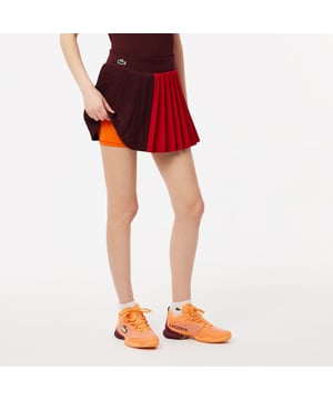 Womens Lacoste SPORT Ultra-Dry Stretch Tennis Skirt with Shorts in bordeaux - orange.Move your way in this pleated skirt with integrated shorts. Lightweight and stretchy  with Ultra Dry technology for comfort. A blend of tradition and innovation to help you perform in style.- Recycled polyester made from manufacturing offcuts - Tonal integrated shorts- Designed for intensive use- Tested by tennis players- Silicone crocodile on side - Main fabric: Polyester (100%) - Integrated shorts: Polyester (82%)  Elastane (18%) - Wristband: Polyester (82%)  Elastane (18%).  Machine washable.- Ref: JF7475-IEJ