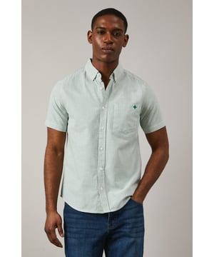 Classic Oxford stripe pattern for timeless appeal
        Short sleeves ideal for warmer weather
        Button-down collar for a smart-casual look
        Chest pocket with embroidered logo detail
        Back pleat for enhanced comfort and movement
    
    This Maine Oxford stripe short sleeve shirt is a versatile addition to any gentleman's wardrobe. The crisp woven fabric and classic stripe pattern create a smart yet relaxed aesthetic, perfect for various casual occasions. Style it effortlessly with dark denim jeans and white trainers for a laid-back weekend look, or pair it with chino shorts and boat shoes for a seaside stroll. The button-down collar adds a touch of refinement, making it suitable for casual Fridays at the office when worn with tailored trousers. Whether you're attending a family barbecue, meeting friends for a pub lunch, or enjoying a sunny day out, this shirt offers both comfort and style. Its breathable cotton composition ensures you stay cool and collected, while the back pleat allows for ease of movement. Embrace the timeless charm of this Oxford shirt and make it your go-to for effortless, British casual style.