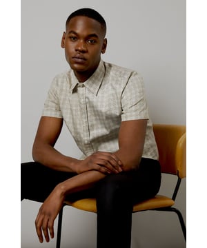 Distinctive tile print pattern for a modern twist on classic style
        Short sleeves perfect for warmer weather or layering
        Versatile button-up design for easy wear
        Comfortable woven cotton fabric for breathability
        Tailored fit flatters the silhouette without being restrictive
    
    This Burton short sleeve shirt presents a fresh take on casual wear, ideal for the man who appreciates a blend of comfort and style. The eye-catching tile print adds visual interest to your ensemble, making it a standout piece for various occasions. Pair it with dark trousers and trainers for a smart-casual look perfect for weekend outings or informal gatherings. The shirt's versatility shines through when worn open over a plain t-shirt with jeans for a relaxed pub meet-up with mates. For family barbecues or outdoor events, roll up the sleeves slightly and team with chino shorts for an effortlessly cool appearance. The woven cotton fabric ensures all-day comfort, whether you're cheering on your favourite team at the local sports bar or enjoying a casual dinner out. This shirt is a wardrobe essential that seamlessly transitions from daytime casual to evening socialising, embodying the spirit of laid-back British style.