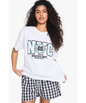Oversized fit for ultimate comfort and laid-back style
        Bold NYC Athletics Dept graphic print for a sporty urban vibe
        Versatile cotton fabric suitable for all-day wear
        Short sleeves and crew neckline for a classic T-shirt silhouette
        Relaxed dropped shoulders enhancing the casual look
    
    Embrace the urban-chic aesthetic with this oversized T-shirt featuring a striking NYC Athletics Dept print. Perfect for those seeking a blend of comfort and style, this versatile piece is ideal for casual outings or relaxed weekends. Pair it with gingham shorts as shown for a playful contrast, or style it with your favourite denim for an effortless everyday look. The roomy fit allows for easy layering - throw on a denim jacket for cooler evenings or wear it over a long-sleeved top when the temperature drops. Dress it up with a leather skirt and trainers for a trendy night out, or keep it casual with joggers for a quick coffee run. This T-shirt is a must-have for the fashion-forward individual who values both comfort and street-style credibility.
