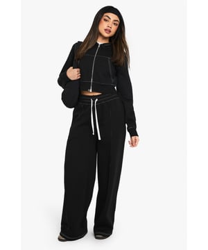 Straight-leg joggers with eye-catching contrast stitching
        Cropped zip-up hoodie for a trendy two-piece look
        Comfortable wide-leg design for effortless movement
        Adjustable drawstring waist for a customised fit
        Versatile style suitable for various casual occasions
    
    Make a statement in these striking straight-leg joggers, perfect for the fashion-forward woman who values both style and comfort. The contrast stitching adds a unique touch to this casual ensemble, setting you apart from the crowd. Pair with the matching cropped hoodie for a coordinated look that's sure to turn heads. The wide-leg design offers unrestricted movement, ideal for running errands or lounging at home. Dress them up with chunky trainers and a leather jacket for a chic street-style vibe, or keep it relaxed with a simple tee and slides for a laid-back weekend look. These joggers are your go-to choice for family gatherings, casual outings with friends, or those days when you want to feel comfy yet put-together. The drawstring waist allows for easy adjustment, ensuring a perfect fit every time you wear them.