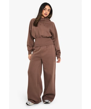 Wide-leg design for a relaxed and trendy silhouette
        Hooded top with a cosy, oversized fit
        Elasticated waistband for comfort and ease
        Practical side pockets for convenience
        Versatile two-piece set perfect for mixing and matching
    
    Embrace laid-back chic with these wide-leg joggers, a must-have addition to your casual wardrobe. The relaxed fit and elasticated waistband offer supreme comfort, while the coordinating hooded top completes the look for effortless style. Perfect for lazy weekends or running errands, this set can be dressed up or down with ease. Pair with trendy trainers and a crossbody bag for a cool, off-duty look, or throw on some statement jewellery and sleek slides for a more polished ensemble. The versatility of this two-piece set makes it ideal for various casual occasions, from coffee dates with friends to family gatherings. With its on-trend silhouette and comfortable fabric, this outfit is sure to become your go-to for those days when you want to look stylish without compromising on comfort.