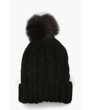 Chunky cable knit design for a classic winter look
        Soft acrylic fabric for comfort and warmth
        Oversized faux fur pom-pom for a playful touch
        Ribbed cuff for a snug fit
        Versatile one-size-fits-all styling
    
    Embrace the chilly weather with this charming Cable Knit Faux Pom Beanie from Boohoo. The chunky cable knit pattern adds a timeless appeal, while the oversized faux fur pom-pom injects a dash of fun to your winter ensemble. Perfect for casual outings or family gatherings, this beanie pairs effortlessly with your favourite jumper and jeans combo. For a trendy look, team it with a longline puffer coat, thermal leggings, and chunky trainers. The versatile design makes it an ideal accessory for various cold-weather activities, from ice skating with friends to cosy walks in the park. With its soft acrylic fabric and snug fit, this beanie ensures you stay warm and stylish throughout the season.