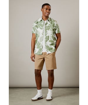 Bold leaf print design for a distinctive summer look
        Short sleeve construction with classic collar for casual comfort
        Button-through front with chest pocket detail
        Crafted from 100% cotton for breathable all-day wear
        Regular fit silhouette that suits most body types
    
    This Burton leaf print shirt brings a touch of tropical flair to your casual wardrobe without compromising on comfort. Perfect for warm-weather socialising, it pairs brilliantly with chino shorts and white trainers as shown for daytime pub garden gatherings. The versatile design works equally well with neutral trousers for evening drinks or family barbecues. The breathable cotton fabric ensures you'll stay comfortable throughout the day, whilst the classic cut maintains a smart-casual balance that Burton is known for. Layer under a lightweight bomber jacket when the temperature drops, or wear open over a plain white t-shirt for a relaxed weekend look. Machine washable at 30 degrees, this shirt combines practicality with effortless style for the modern British man who values both tradition and contemporary design.