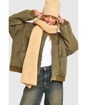 Chunky ribbed knit texture for added warmth and style
        Generous length for versatile wrapping and draping
        Classic rectangular shape suits various styling options
        Soft, cosy fabric blend for ultimate comfort
        Timeless design complements diverse outfits
    
    Wrap yourself in comfort and style with this long ribbed knit scarf from Boohoo. Perfect for brisk autumn days or chilly winter evenings, this versatile accessory adds a touch of cosiness to any ensemble. The chunky ribbed texture not only provides extra warmth but also creates a visually appealing pattern that catches the eye. Style it loosely draped over a casual jacket for a relaxed look, or wrap it snugly around your neck for maximum protection against the elements. Pair with jeans, trainers, and an oversized coat for an effortlessly chic everyday outfit. Whether you're heading to a casual coffee date or a weekend shopping trip, this scarf is the ideal finishing touch to your look, combining practicality with on-trend fashion sensibility.