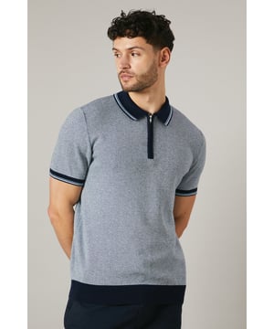Birdseye knitted texture for a sophisticated look
        Contrasting collar and cuffs for a smart finish
        Quarter-zip neckline for adjustable comfort
        Short sleeves ideal for warmer weather
        Versatile design suitable for various casual occasions
    
    This Maine birdseye knitted polo shirt combines comfort with style, making it a versatile addition to your wardrobe. The textured knit adds depth and interest to the garment, while the contrasting collar and cuffs create a refined edge. Perfect for casual outings, this polo can be effortlessly styled for a range of events. Pair it with dark trousers and white trainers for a smart-casual look ideal for family gatherings or weekend brunches. The quarter-zip neckline allows for customisable comfort, adapting to your preference and the weather. Made from 100% cotton, this polo ensures breathability and ease of care, making it a practical choice for the modern man who values both style and functionality. Whether you're heading to a casual meet-up with friends or a relaxed day out, this Maine polo will keep you looking polished without compromising on comfort.
