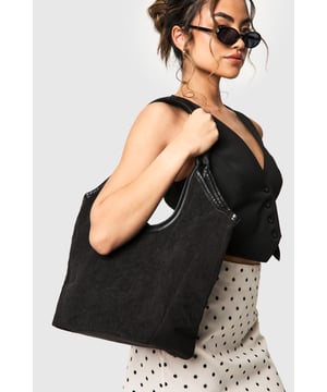 Spacious corduroy tote bag with contrasting PU trim
        Versatile design suitable for everyday use
        Sturdy double handles for comfortable carrying
        Roomy interior perfect for all your essentials
        Textured corduroy fabric adds a trendy touch
    
    This chic corduroy tote bag is the perfect companion for your daily adventures. The textured fabric adds a fashionable flair to your outfit, while the contrasting PU trim provides a sleek finish. Its generous size ensures you can carry all your necessities with ease, making it ideal for work, shopping, or casual outings. Style it with a cosy jumper and your favourite jeans for a laid-back look, or pair it with a flowy dress and ankle boots for a more polished ensemble. Whether you're heading to uni, meeting friends for coffee, or running errands, this versatile bag will keep you organised and on-trend. The durable construction and practical design make it a must-have accessory for the fashion-forward woman who values both style and functionality in her wardrobe.