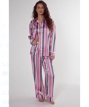 Luxurious satin finish with eye-catching multi-stripe pattern throughout
        Oversized shirt design with classic collar and button-through front
        Long sleeves with contrast piping detail at cuffs
        Relaxed fit trousers with wide leg silhouette for ultimate comfort
        Coordinated set designed for effortless nightwear styling
    
    Embrace laid-back luxury with this striking satin pyjama set from Nasty Gal. The oversized shirt silhouette offers a contemporary twist on classic nightwear, whilst the vibrant stripe pattern adds a playful touch to your evening routine. Perfect for those who appreciate comfort without compromising on style, this set transitions seamlessly from night to morning. Pair with fluffy slippers for cosy nights in, or throw on with trainers for a quick dash to the corner shop. The relaxed wide-leg trousers provide unrestricted movement, making this set ideal for lounging during family gatherings or weekend brunches at home. The contrasting piped trim adds a refined finishing touch to this already standout set, ensuring you look put-together even in your downtime.