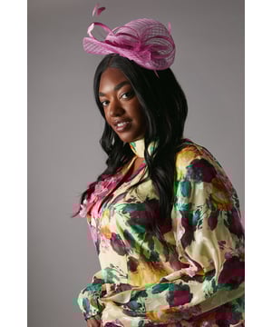 Offering a bold take on race-day style or adding a flair to wedding guest dressing, fascinators are our favourite accessory. Beautifully complementing our formal outfitting, this hat is an instant sartorial statement. Crafted out of signature sinamay, a natural straw fabric made from abaca fibres, this  piece uses an open weave to add texture and is sculpted into loops. Fixes with a headband and delivered in a box.