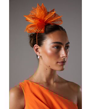 Exquisite open weave design with delicate bow and feather detailing
Lightweight and airy fascinator crafted from fancy fabric
Headpiece features a slender, curved headband for a secure fit
Intricate weave pattern creates a captivating textural effect
Versatile accessory to elevate your ensemble for formal occasions

Radiate sophistication and elegance with this stunning fascinator from Coast. The open weave design, adorned with a delicate bow and feather embellishments, exudes a refined and feminine aesthetic. Crafted from a lightweight and airy fancy fabric, this headpiece is the perfect accompaniment to your formal attire, whether you're attending a wedding, the races, or a graduation ceremony. Its slender, curved headband ensures a secure and comfortable fit, allowing you to confidently embrace the occasion. Style this versatile fascinator with a tailored dress or a chic jumpsuit for a polished and sophisticated look that commands attention.