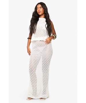 Intricate crochet pattern throughout the co-ord set for a textured, handcrafted appeal
        Peplum crop top with decorative button detail and eye-catching keyhole front
        Figure-hugging maxi skirt with side split for ease of movement
        Sleeveless design perfect for warm-weather styling
        Coordinated two-piece set that can be worn together or styled separately
    
    Make a statement in this beautifully crafted crochet co-ord set from Boohoo. The peplum top features a distinctive keyhole front with button detailing, creating a flattering silhouette that draws attention to your dcolletage. The matching maxi skirt hugs your curves and includes a practical side split that adds movement to your stride. Style with gold-toned bangles as seen on our model for a beach-ready look, or dress it up for summer garden parties with strappy sandals and a woven clutch. For casual daytime outings, layer the top over a bandeau and pair with denim shorts, or team the skirt with a simple vest top and trainers for an effortlessly chic ensemble. This versatile co-ord transitions seamlessly from relaxed family gatherings to sunset drinks with friends.