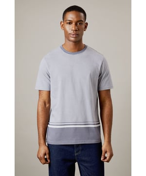 Distinctive striped hem design for a modern twist
        Comfortable jersey fabric for all-day wear
        Versatile crew neck style
        Short sleeves perfect for warmer days
        Relaxed fit suitable for various body types
    
    This Burton t-shirt combines classic style with a contemporary edge, making it a versatile addition to any casual wardrobe. The distinctive striped hem adds a subtle yet eye-catching detail, perfect for the man who appreciates understated flair. Pair it with your favourite denim for a laid-back pub outing with mates, or dress it up with chinos for a family barbecue. The relaxed fit and soft jersey fabric ensure comfort whether you're cheering on your team at a sports match or running weekend errands. Ideal for the gentleman who values both style and practicality, this t-shirt effortlessly transitions from a casual day out to an evening of relaxed socialising. Layer it under a light jacket for cooler evenings or wear it on its own for a effortlessly cool look that speaks to your refined taste in casual wear.