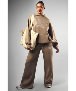 Straight-leg joggers for a relaxed, comfortable fit
        Distinctive DSGN embroidery adds a stylish touch
        Coordinating hoodie available for a complete ensemble
        Wide-leg design offers freedom of movement
        Versatile piece suitable for various casual occasions
    
    Embrace laid-back chic with these straight-leg joggers, perfect for the fashion-forward woman who values both style and comfort. The distinctive DSGN embroidery adds a trendy element, setting these joggers apart from your average loungewear. Pair them with the matching hoodie for an effortlessly cool coordinated look, or mix and match with other casual pieces in your wardrobe. The wide-leg design ensures unrestricted movement, making these joggers ideal for running errands, meeting friends for coffee, or relaxing at home. Style them with chunky trainers and a cropped tee for a street-style inspired outfit, or dress them up slightly with a fitted bodysuit and statement jewellery for casual gatherings. These versatile joggers are a must-have addition to any young woman's wardrobe, offering endless styling possibilities for various casual occasions.