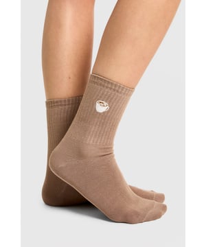 Set of three pairs of socks with charming coffee-themed embroidery
        Ribbed design for a snug and comfortable fit
        Versatile neutral colour palette suitable for various outfits
        Ankle-length style perfect for trainers and casual footwear
        One size fits most for convenience and ease of wear
    
    Add a dash of whimsy to your everyday attire with this delightful 3-pack of coffee-embroidered socks from Boohoo. These playful ankle-length socks feature charming coffee cup and croissant motifs, perfect for showcasing your love for your morning brew. The ribbed design ensures a snug fit that won't slip down throughout the day, while the neutral colour palette makes them versatile enough to pair with a wide range of casual ensembles. Style these fun socks with your favourite trainers and a relaxed denim look for a laid-back weekend brunch, or let them peek out from beneath cropped trousers for a touch of personality at casual gatherings. Whether you're a coffee enthusiast or simply appreciate a quirky accessory, these socks are sure to become a staple in your hosiery collection, adding a subtle yet stylish element to your everyday looks.