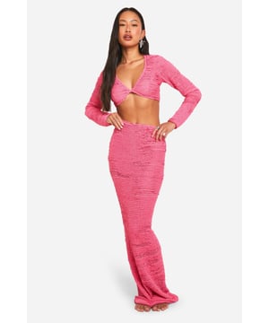 Textured knit two-piece set featuring a crop top and maxi skirt
        Plunging neckline for a daring beach look
        Long sleeves on the top for versatile styling options
        Figure-hugging silhouette accentuates curves
        Floor-length skirt with a body-contouring fit
    
    Make a statement on your next beach getaway with this eye-catching textured knit set. The plunging neckline of the crop top adds a touch of allure, while the long sleeves offer versatility for cooler evenings or sun protection. The matching maxi skirt hugs your curves, creating a sleek silhouette from top to bottom. Perfect for strolling along the shoreline or sipping cocktails at a beachside bar, this set can be dressed up or down with ease. Pair with strappy sandals and oversized sunglasses for a chic daytime look, or add statement earrings and a clutch bag for a glamorous evening ensemble. Whether you're lounging by the pool or dancing the night away at a beach party, this Boohoo two-piece is sure to turn heads and keep you feeling confident and stylish throughout your sun-soaked adventures.