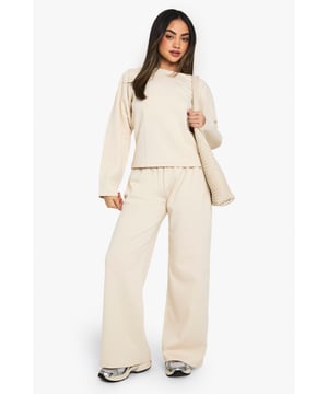 Wide-leg design for a relaxed and comfortable fit
        High-rise waistband for a flattering silhouette
        Soft, textured fabric for ultimate comfort
        Versatile style suitable for various casual occasions
        Coordinating top available for a matching set look
    
    Embrace laid-back chic with these wide-leg joggers from Boohoo. Perfect for the fashion-forward woman who values both style and comfort, these trousers offer a contemporary twist on classic loungewear. The high-rise waistband creates a sleek silhouette, while the wide-leg cut provides ample room for movement. Pair with the matching top for an effortlessly coordinated ensemble, or mix and match with your wardrobe staples for versatile styling options. Ideal for casual outings, weekend brunches, or relaxed evenings in, these joggers can be dressed up with trainers and a cropped jacket for a street-style inspired look. The textured fabric adds a touch of interest to your outfit, making these joggers a standout piece in your casual wardrobe. Whether you're running errands or meeting friends for a coffee, these wide-leg joggers will keep you comfortable and on-trend throughout the day.